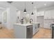 Modern kitchen with an island, pendant lighting, stainless steel appliances, and light wood floors at 1912 St John St, Charlotte, NC 28216