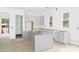 Bright kitchen with unfinished cabinets and island; natural light from multiple windows at 1912 St John St, Charlotte, NC 28216