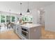 Bright, open kitchen featuring an island with modern appliances adjacent to the dining and living areas at 1912 St John St, Charlotte, NC 28216