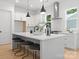 Modern kitchen featuring white cabinetry, a large island with seating, and stainless steel appliances at 1912 St John St, Charlotte, NC 28216