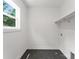 A functional laundry room features black hexagon tiles and ample storage space at 1912 St John St, Charlotte, NC 28216