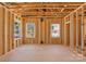 Open-concept living area in a new construction featuring wood framing, natural light, and unfinished elements at 1912 St John St, Charlotte, NC 28216