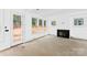 Bright living room featuring a fireplace, large windows, and neutral walls at 1912 St John St, Charlotte, NC 28216