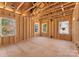 Large new construction living room framed, featuring exposed beams and large windows for ample natural light at 1912 St John St, Charlotte, NC 28216