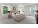 Cozy main bedroom with a neutral color palette, carpeted floor, and abundant natural light at 1912 St John St, Charlotte, NC 28216