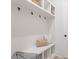 Functional mudroom with built-in bench, storage hooks, and shelving for organized entry at 1912 St John St, Charlotte, NC 28216