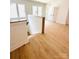 Upstairs landing featuring light wood floors and a staircase with a wooden handrail at 1912 St John St, Charlotte, NC 28216