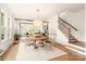 Bright dining room with a large wooden table and chandelier, open to living room at 1920 Hamorton Pl, Charlotte, NC 28205