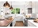 Bright kitchen with white cabinets, wood countertops, and island at 1920 Hamorton Pl, Charlotte, NC 28205