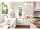 Modern kitchen with white cabinets and a farmhouse sink at 1920 Hamorton Pl, Charlotte, NC 28205