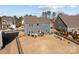 Aerial view of backyard, complete with an outdoor kitchen, a patio dining set, play equipment, and a fenced yard at 2025 Killian Creek Dr, Denver, NC 28037