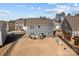 Aerial view of backyard, complete with an outdoor kitchen, a patio dining set, play equipment, and a fenced yard at 2025 Killian Creek Dr, Denver, NC 28037