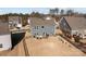 Aerial view of backyard, complete with an outdoor kitchen, a patio dining set, play equipment, and a fenced yard at 2025 Killian Creek Dr, Denver, NC 28037