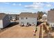 Aerial view of backyard, complete with an outdoor kitchen, a patio dining set, play equipment, and a fenced yard at 2025 Killian Creek Dr, Denver, NC 28037