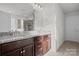 Bathroom with dual sinks, granite countertop, dark cabinetry, and shower with glass enclosure at 2025 Killian Creek Dr, Denver, NC 28037