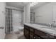 Bathroom showcasing dual sinks with granite countertop, dark cabinetry, and a shower-tub combination at 2025 Killian Creek Dr, Denver, NC 28037