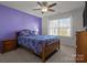 Cozy bedroom with purple accent wall, ceiling fan, and bright window at 2025 Killian Creek Dr, Denver, NC 28037