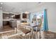 Bright dining area featuring a wooden table and bench, with views of the backyard through sliding glass doors at 2025 Killian Creek Dr, Denver, NC 28037