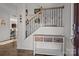 Inviting foyer features staircase with decorative iron railing and a console table, providing a warm greeting at 2025 Killian Creek Dr, Denver, NC 28037