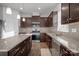 Well-equipped kitchen with granite countertops, stainless steel appliances, and dark wood cabinetry at 2025 Killian Creek Dr, Denver, NC 28037