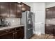 Modern kitchen with stainless steel refrigerator and dark wood cabinetry at 2025 Killian Creek Dr, Denver, NC 28037