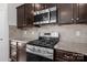 The kitchen features stainless steel oven range and appliances, set against granite countertops at 2025 Killian Creek Dr, Denver, NC 28037