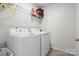 The laundry room includes a washer, dryer, and wire rack shelving at 2025 Killian Creek Dr, Denver, NC 28037