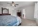 Comfortable main bedroom featuring a ceiling fan, neutral carpet, and access to the bathroom at 2025 Killian Creek Dr, Denver, NC 28037