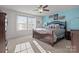 Spacious main bedroom with a ceiling fan, bright windows, and a lovely blue accent wall at 2025 Killian Creek Dr, Denver, NC 28037