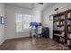 Bright home office featuring a large window, built-in bookcase, and hardwood floors, ideal for remote work at 2025 Killian Creek Dr, Denver, NC 28037