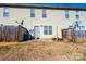 Townhouse backyard with wooden fence, small patio, and satellite dishes at 217 22Nd Sw St # H, Hickory, NC 28602