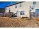 Townhouse backyard with wooden fence, small patio, and satellite dishes at 217 22Nd Sw St # H, Hickory, NC 28602