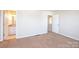 Bright bedroom featuring carpet, an ensuite bathroom, and hallway access at 217 22Nd Sw St # H, Hickory, NC 28602