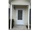 Front entrance with white door and storm door, featuring a covered porch at 217 22Nd Sw St # H, Hickory, NC 28602