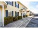 Row of townhouses with light yellow siding, dark shutters, and landscaping at 217 22Nd Sw St # H, Hickory, NC 28602