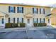 Two-unit townhouse building with light yellow siding, dark shutters, and covered entries at 217 22Nd Sw St # H, Hickory, NC 28602