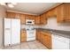 Kitchen with wood cabinets, granite counters, and white appliances at 217 22Nd Sw St # H, Hickory, NC 28602