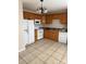 Kitchen with wood cabinets, white appliances, and tile floors at 217 22Nd Sw St # H, Hickory, NC 28602