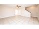 Living room with tile floors, ceiling fan, and staircase at 217 22Nd Sw St # H, Hickory, NC 28602