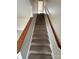 Carpeted staircase with wooden handrail at 217 22Nd Sw St # H, Hickory, NC 28602