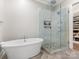 Elegant bathroom with soaking tub, glass shower, and built-in shelving at 2223 Croydon Rd # 103, Charlotte, NC 28207