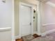 Residential hallway with a white door and neutral wall color at 2223 Croydon Rd # 103, Charlotte, NC 28207