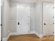 Hallway with white doors and hardwood floors at 2223 Croydon Rd # 103, Charlotte, NC 28207