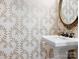 Small powder room with elegant wallpaper and a pedestal sink at 2223 Croydon Rd # 103, Charlotte, NC 28207