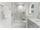 Clean bathroom with walk-in shower, gray tile, and a built-in shower seat at 2234 Revolution Park Dr, Charlotte, NC 28208