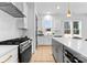 Modern kitchen with stainless steel appliances and white and gray cabinetry at 2234 Revolution Park Dr, Charlotte, NC 28208