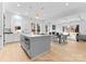 Modern kitchen with gray island, white cabinets, and stainless steel appliances at 2234 Revolution Park Dr, Charlotte, NC 28208