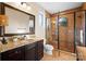 Bathroom with granite countertop, dark wood cabinets and a walk-in shower at 237 Wilson Lake Rd, Mooresville, NC 28117