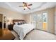 Spacious bedroom with a king-size bed, and French doors leading to a balcony at 237 Wilson Lake Rd, Mooresville, NC 28117