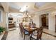 Beautiful dining area with elegant chandelier and tray ceilings, flowing seamlessly into the living room and kitchen at 237 Wilson Lake Rd, Mooresville, NC 28117